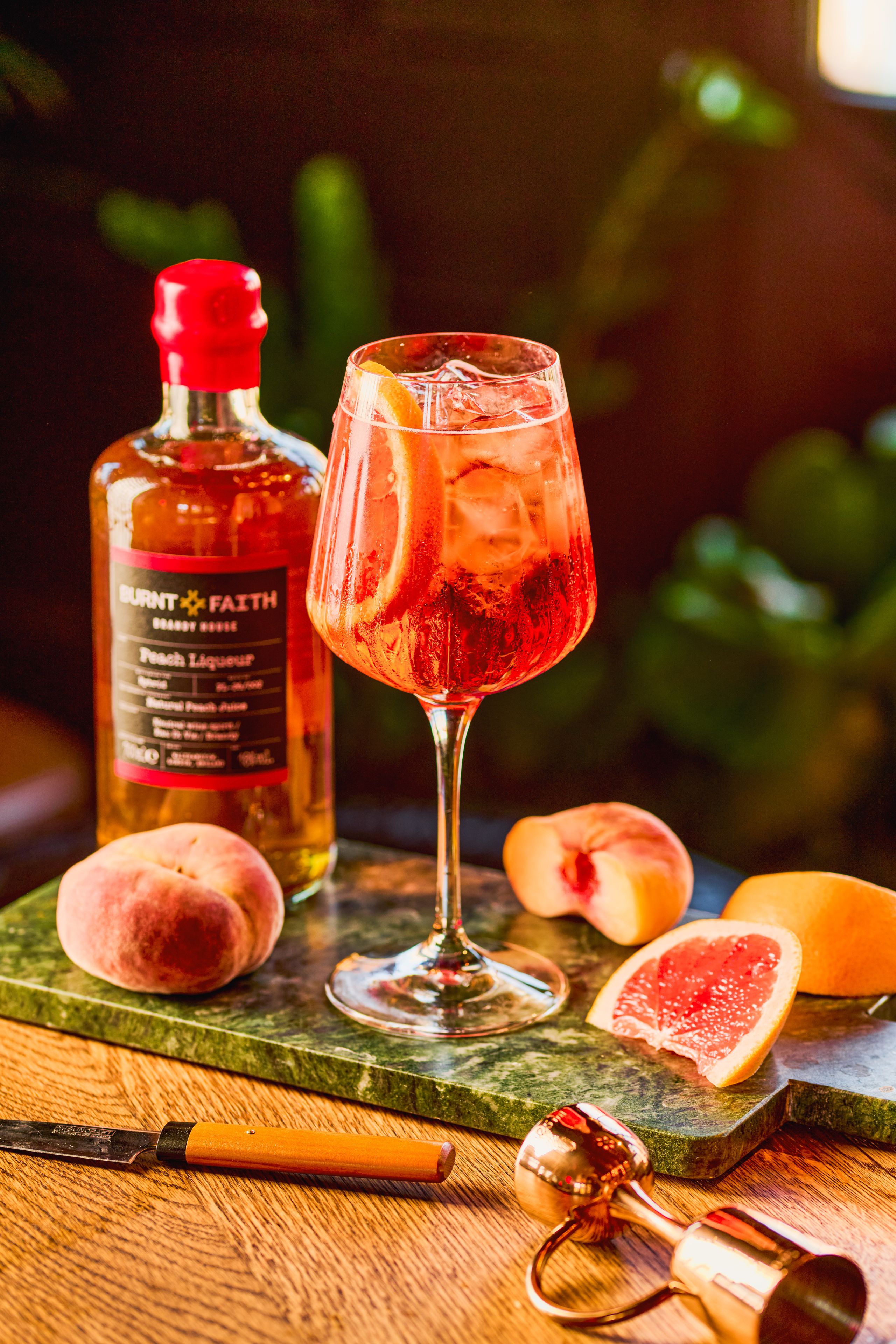 Winter cocktails served in a cosy outdoor setting, surrounded by warm lights and festive winter greenery.