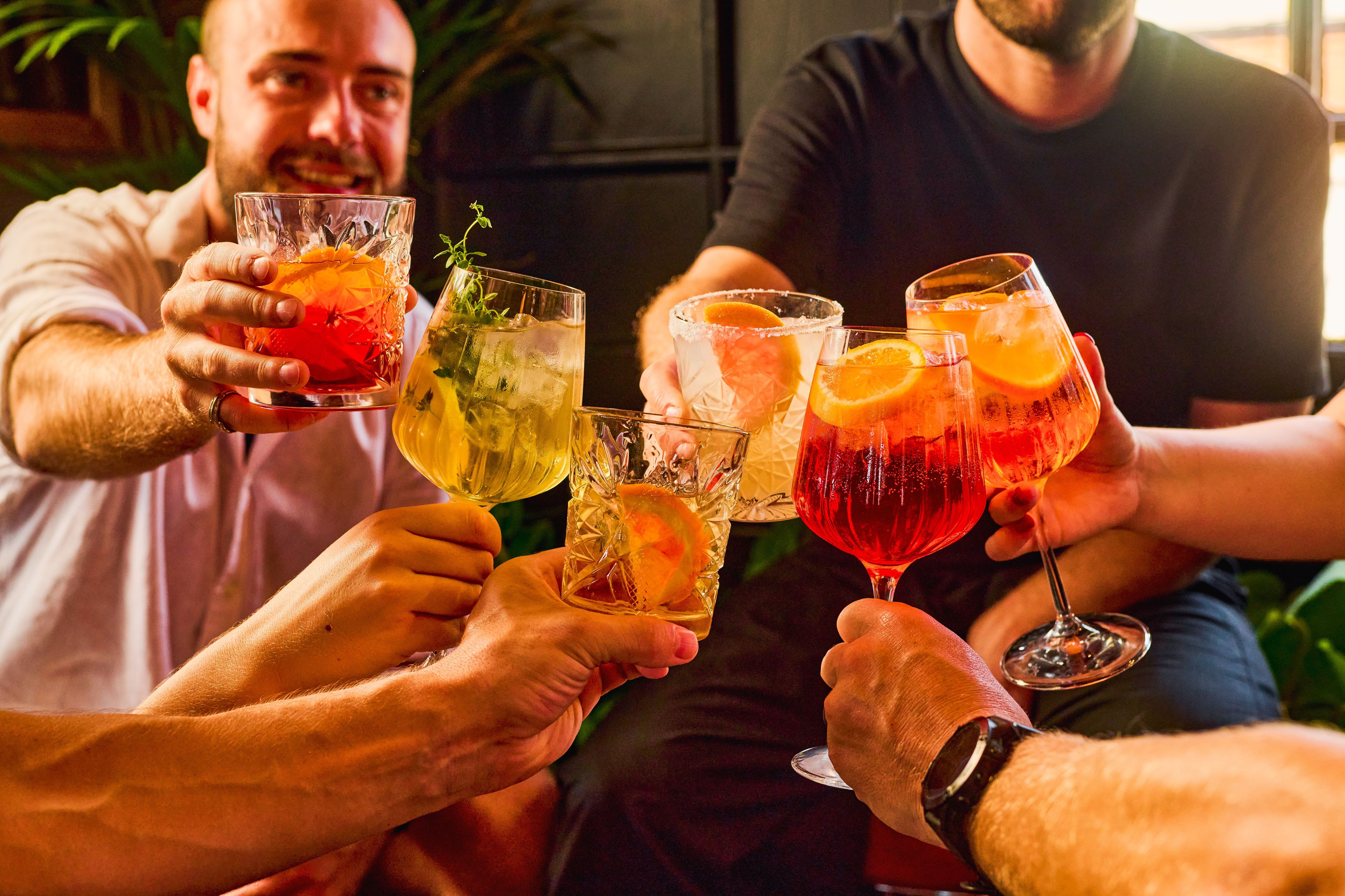 Selection of winter cocktails served in elegant glasses at a cosy London pub.